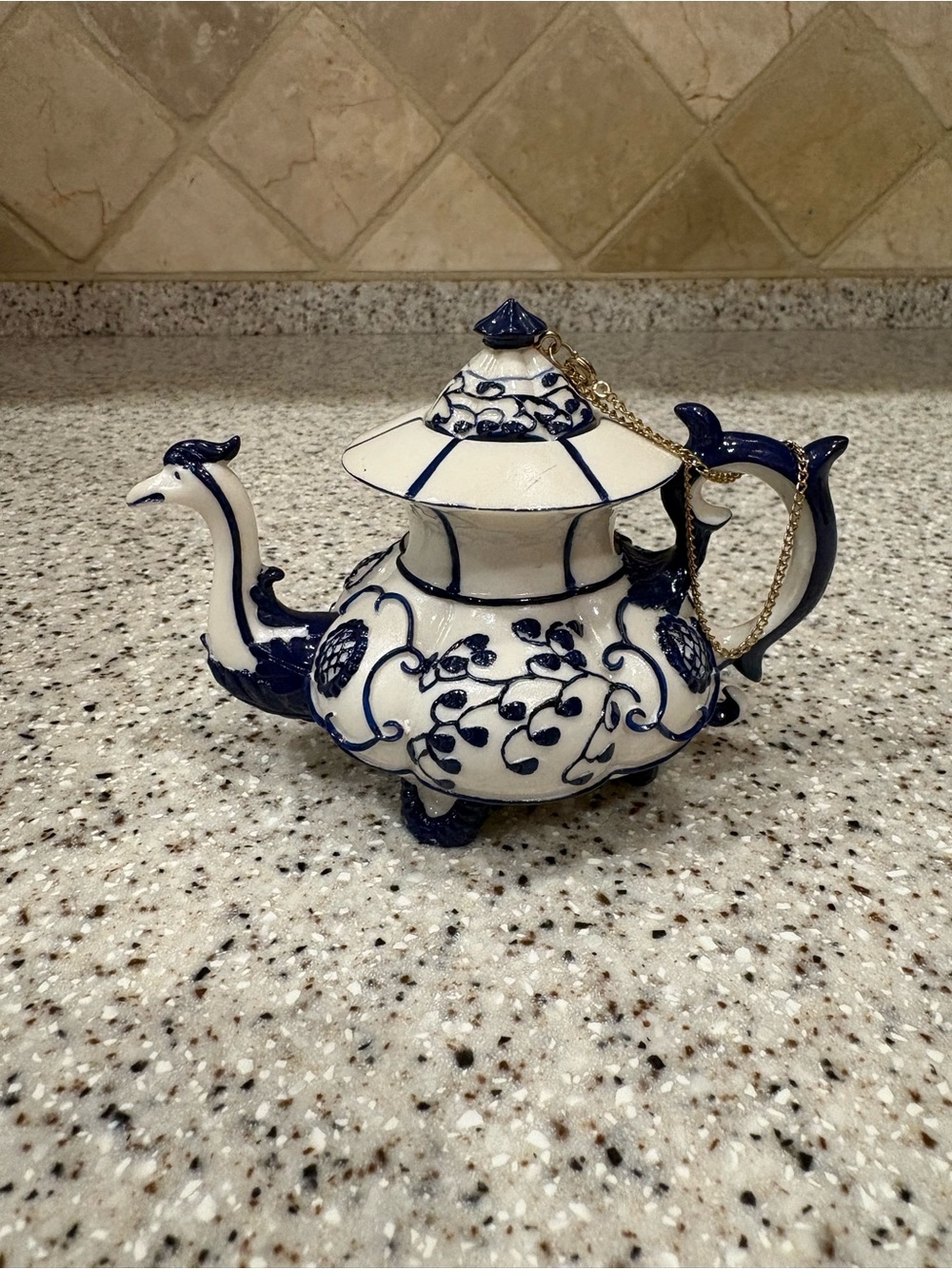 Blue and White Ceramic Teapot with Floral Scroll Design